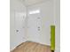 Well-lit entryway with a white front door, closet door, and light wood-look flooring at 1828 Aston Mill Pl, Charlotte, NC 28273