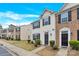 Exterior view of townhomes showcasing sidewalks, and landscaped yards at 1828 Aston Mill Pl, Charlotte, NC 28273
