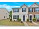 Two-story townhome featuring black shutters and a well-manicured lawn at 1828 Aston Mill Pl, Charlotte, NC 28273