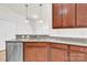 Kitchen area with stainless dishwasher, wood cabinets, and granite countertops at 1828 Aston Mill Pl, Charlotte, NC 28273