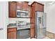 Kitchen area with stainless appliances, wood cabinets and granite countertops at 1828 Aston Mill Pl, Charlotte, NC 28273