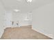 Open concept living room with neutral paint and carpet leads to staircase at 1828 Aston Mill Pl, Charlotte, NC 28273