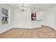 Open-concept living room with pendant lighting and adjacent kitchen at 1828 Aston Mill Pl, Charlotte, NC 28273