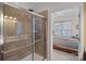 Modern shower boasts tile surround and glass door; bedroom can be seen beyond bathroom door at 18742 Nautical Dr # 301, Cornelius, NC 28031
