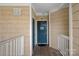 Condo entrance with a blue door, decorative welcome sign, and neutral siding for a cozy welcome at 18742 Nautical Dr # 301, Cornelius, NC 28031