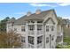 Multi-story condo building showcasing balconies, neutral siding, and beautiful architectural details at 18742 Nautical Dr # 301, Cornelius, NC 28031