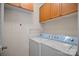 Dedicated laundry room equipped with a washer, dryer, and upper cabinets for storage solutions at 18742 Nautical Dr # 301, Cornelius, NC 28031
