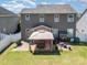 Aerial view of a spacious backyard with a large paver patio, gazebo, grill, and lush green grass at 190 Silverspring Pl, Mooresville, NC 28117