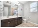 Bright bathroom featuring double sink vanity with dark wood cabinets, large mirror, and tile flooring at 190 Silverspring Pl, Mooresville, NC 28117