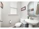 Powder room featuring neutral paint, wood floors, and modern fixtures at 190 Silverspring Pl, Mooresville, NC 28117