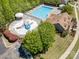 Community pool and splashpad area with landscaping, seating, and parking, surrounded by mature trees at 190 Silverspring Pl, Mooresville, NC 28117