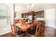 Dining area boasts hardwood floors, dark wood cabinets, stainless appliances and view into kitchen at 190 Silverspring Pl, Mooresville, NC 28117