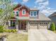Charming two-story home with stone accents, a front porch, and a three-car attached garage at 190 Silverspring Pl, Mooresville, NC 28117