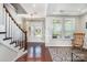 Bright foyer with hardwood floors, staircase, and a view to the front door at 190 Silverspring Pl, Mooresville, NC 28117