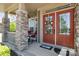 Inviting front porch with a double door entrance, stone pillars, and outdoor seating at 190 Silverspring Pl, Mooresville, NC 28117