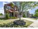 Inviting two-story home featuring a well-manicured lawn and a charming front porch with stone accents and an American flag at 190 Silverspring Pl, Mooresville, NC 28117