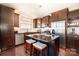 Well-lit kitchen boasts stainless steel appliances, an island with seating, and dark wood cabinets at 190 Silverspring Pl, Mooresville, NC 28117