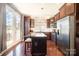 Bright kitchen features an island, stainless appliances, dark wood cabinets, and door to outdoor space at 190 Silverspring Pl, Mooresville, NC 28117