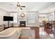 Bright living room with hardwood floors, a fireplace, and an open view to the dining area at 190 Silverspring Pl, Mooresville, NC 28117