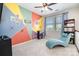Bright and inviting play room with colorful geometric wall design and cozy chaise lounge seating near sunny window at 190 Silverspring Pl, Mooresville, NC 28117