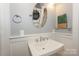 A powder room with a modern vessel sink and a wall mirror at 203 Mt Holly Huntersville Rd, Huntersville, NC 28078