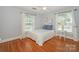 A well-lit bedroom with hardwood floors and windows at 203 Mt Holly Huntersville Rd, Huntersville, NC 28078