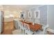 Dining area with wooden table and seating for six, adjacent to the kitchen at 203 Mt Holly Huntersville Rd, Huntersville, NC 28078