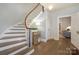 Welcoming foyer with a curved staircase, hardwood floors, and sophisticated lighting at 203 Mt Holly Huntersville Rd, Huntersville, NC 28078