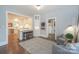 Bright living room with dark wood floors that opens to the kitchen with bar stool seating at 203 Mt Holly Huntersville Rd, Huntersville, NC 28078