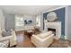 Bright living room with hardwood floors, fireplace, and comfortable seating at 203 Mt Holly Huntersville Rd, Huntersville, NC 28078