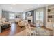 Open-concept living room featuring a fireplace, dining area, and built-in shelving at 203 Mt Holly Huntersville Rd, Huntersville, NC 28078