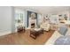 Cozy living room featuring a fireplace, built-in bookshelves, and hardwood floors at 203 Mt Holly Huntersville Rd, Huntersville, NC 28078
