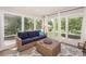 Bright sun room with comfortable furniture, large windows, and a serene backyard view at 203 Mt Holly Huntersville Rd, Huntersville, NC 28078