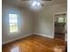 Bright bedroom with wood floors and a ceiling fan, offering a comfortable space at 211 W 2Nd St, Kershaw, SC 29067