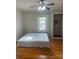 Bright bedroom featuring hardwood floors, a ceiling fan, and closet at 211 W 2Nd St, Kershaw, SC 29067