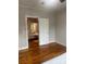 Bedroom with hardwood floors and doorway view to a bathroom with natural light at 211 W 2Nd St, Kershaw, SC 29067