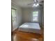 A bedroom with hardwood floors and large windows that allow natural light to flood the space at 211 W 2Nd St, Kershaw, SC 29067