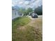 The front yard has some grass and a large driveway at 211 W 2Nd St, Kershaw, SC 29067