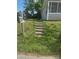 Green mailbox stands near concrete steps ascending to a quaint home at 211 W 2Nd St, Kershaw, SC 29067