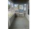 A cozy porch with a screen door, offering a relaxing space to enjoy the outdoors at 211 W 2Nd St, Kershaw, SC 29067