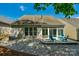 Back of house shows the patio and seating; a gravel yard separates the grass at 2136 Ashley River Rd, Waxhaw, NC 28173