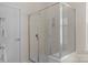 Bathroom with a glass enclosed shower stall, towel rack, and white door at 2136 Ashley River Rd, Waxhaw, NC 28173