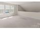 Bonus room offers ample space with natural light and neutral carpet at 2136 Ashley River Rd, Waxhaw, NC 28173