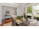 Bright dining room with wainscoting, a decorative chandelier, and large windows at 2136 Ashley River Rd, Waxhaw, NC 28173