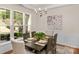Bright dining room with wainscoting, a decorative chandelier, and large windows at 2136 Ashley River Rd, Waxhaw, NC 28173