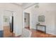 Hallway with hardwood floors, wainscoting, access to the staircase, and views of the kitchen at 2136 Ashley River Rd, Waxhaw, NC 28173