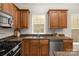 Well-lit kitchen features stainless steel appliances and granite countertops at 2136 Ashley River Rd, Waxhaw, NC 28173