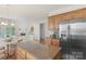 Kitchen island featuring granite countertops and stainless steel refrigerator at 2136 Ashley River Rd, Waxhaw, NC 28173