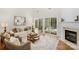 Bright living room featuring hardwood floors, fireplace and access to the patio at 2136 Ashley River Rd, Waxhaw, NC 28173