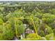 Aerial view highlighting property lines of a house and outbuildings nestled in a lush, wooded area at 214 Creek View Rd, Mooresville, NC 28117